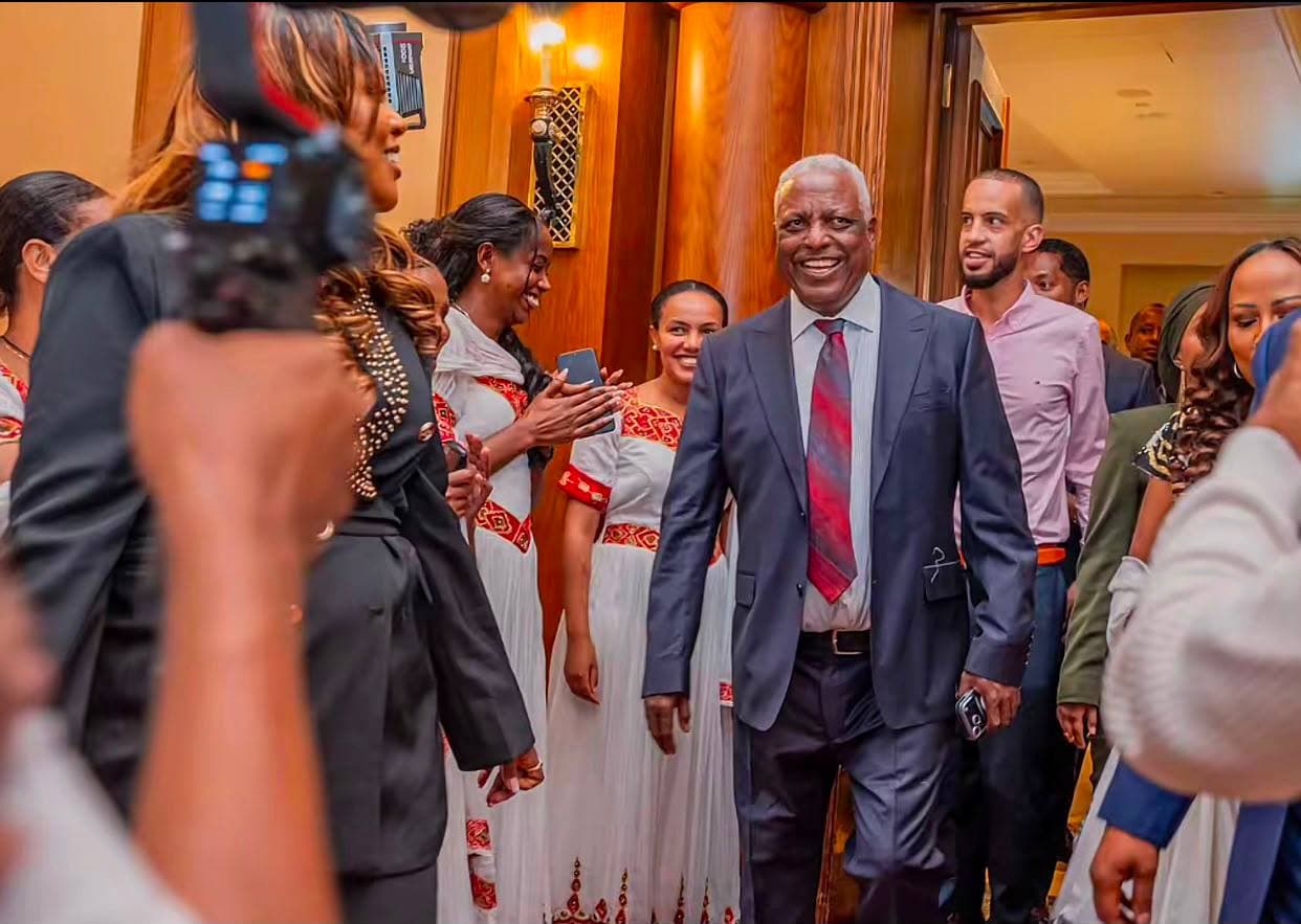 Guest of honour greeted by hosts on arrival at a book launch ballroom